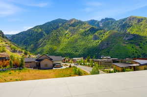 Mountainous landscape with lush green foliage and scattered rock formations
