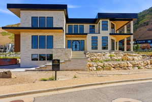 Contemporary architectural design featuring stone facade accents and a flat roofline
