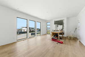 Spacious interior featuring light wood-finish flooring, recessed lighting, and white walls