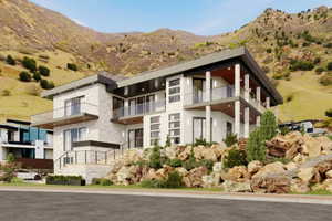 Contemporary multi-level residence featuring stacked stone and smooth stucco exterior finishes