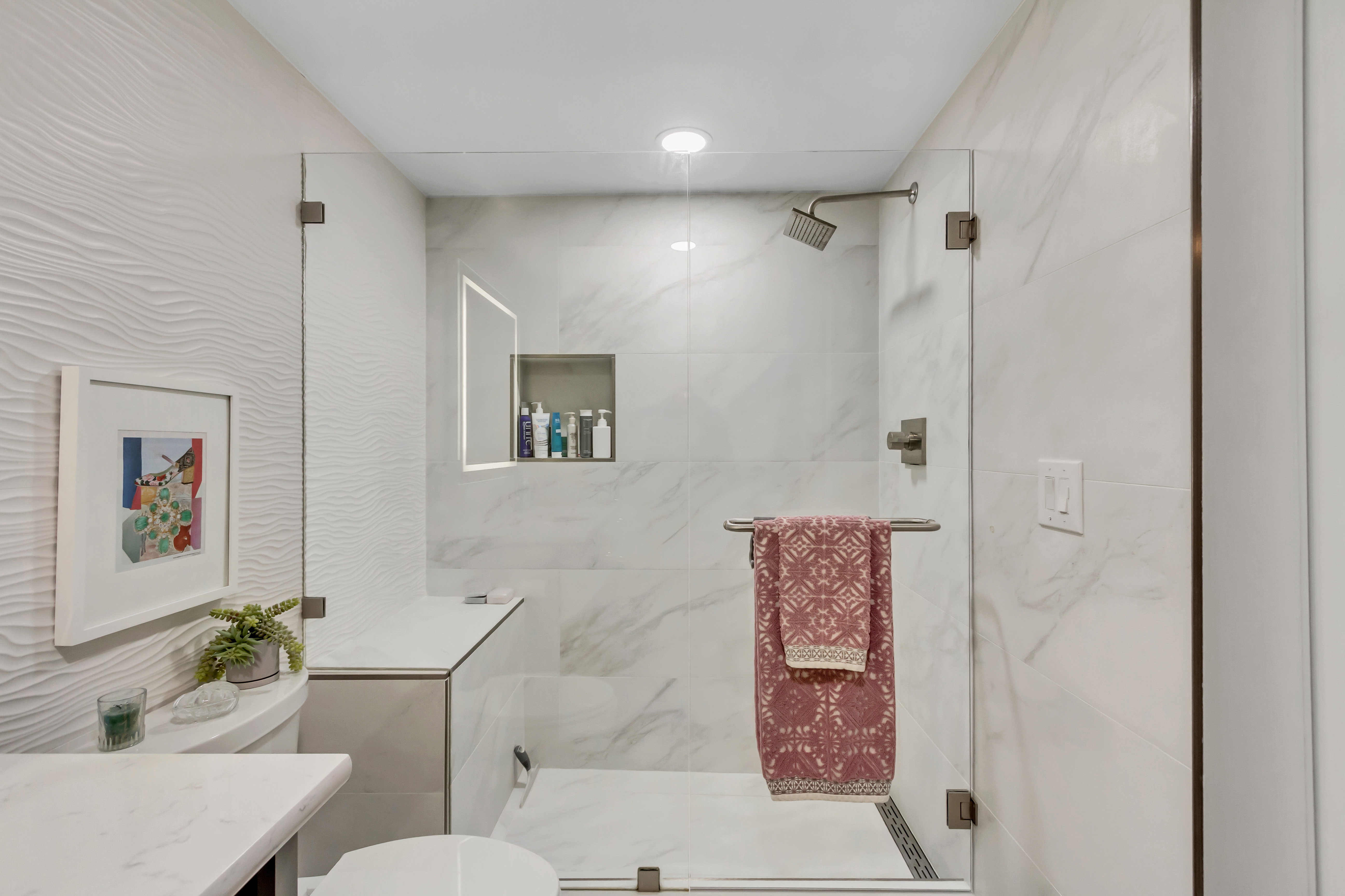 Modern shower enclosure with clear glass panels and brushed nickel hardware