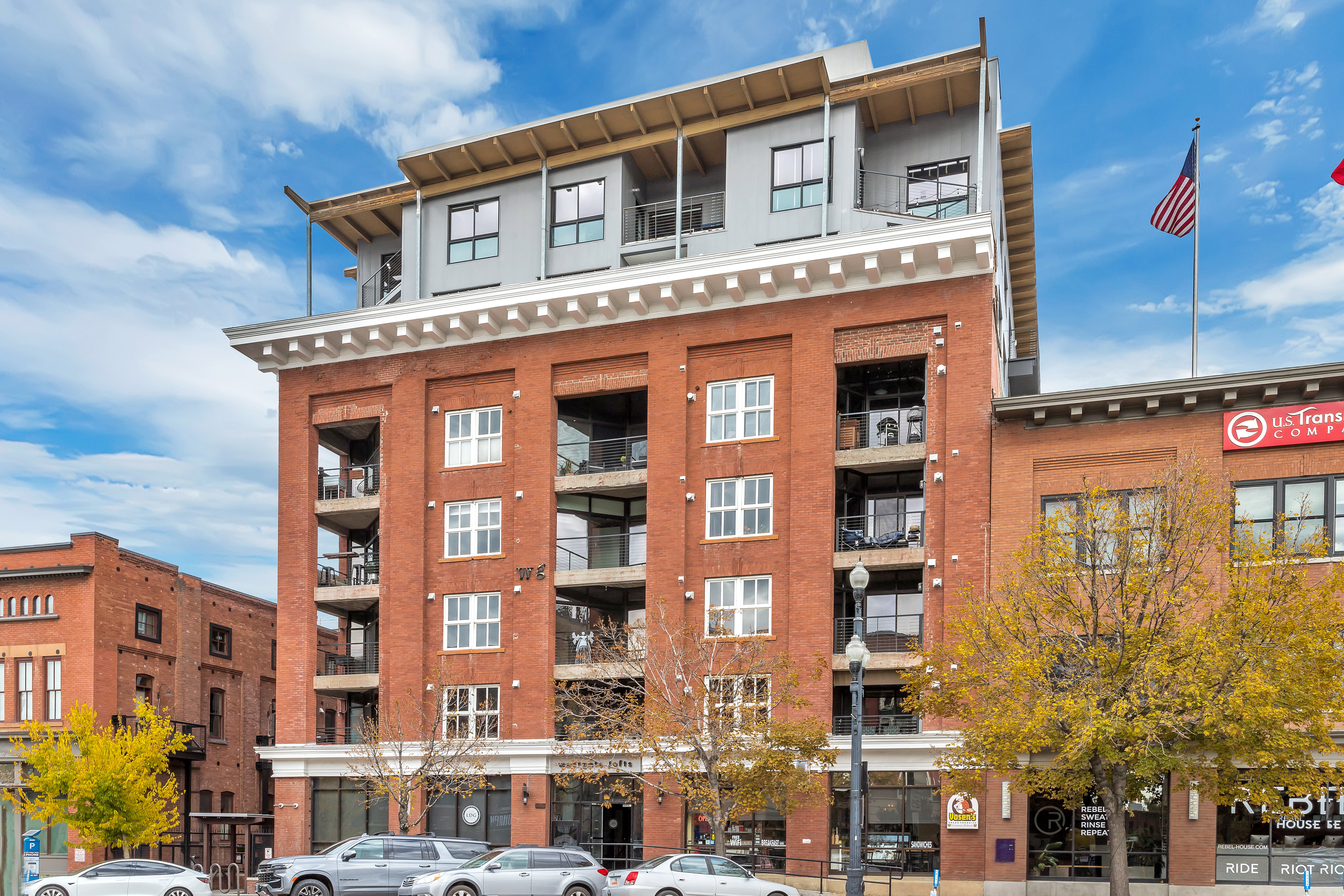 Red brick facade building featuring a white cornice and integrated balconies