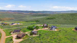 Expansive open land with rolling hills and distant mountains