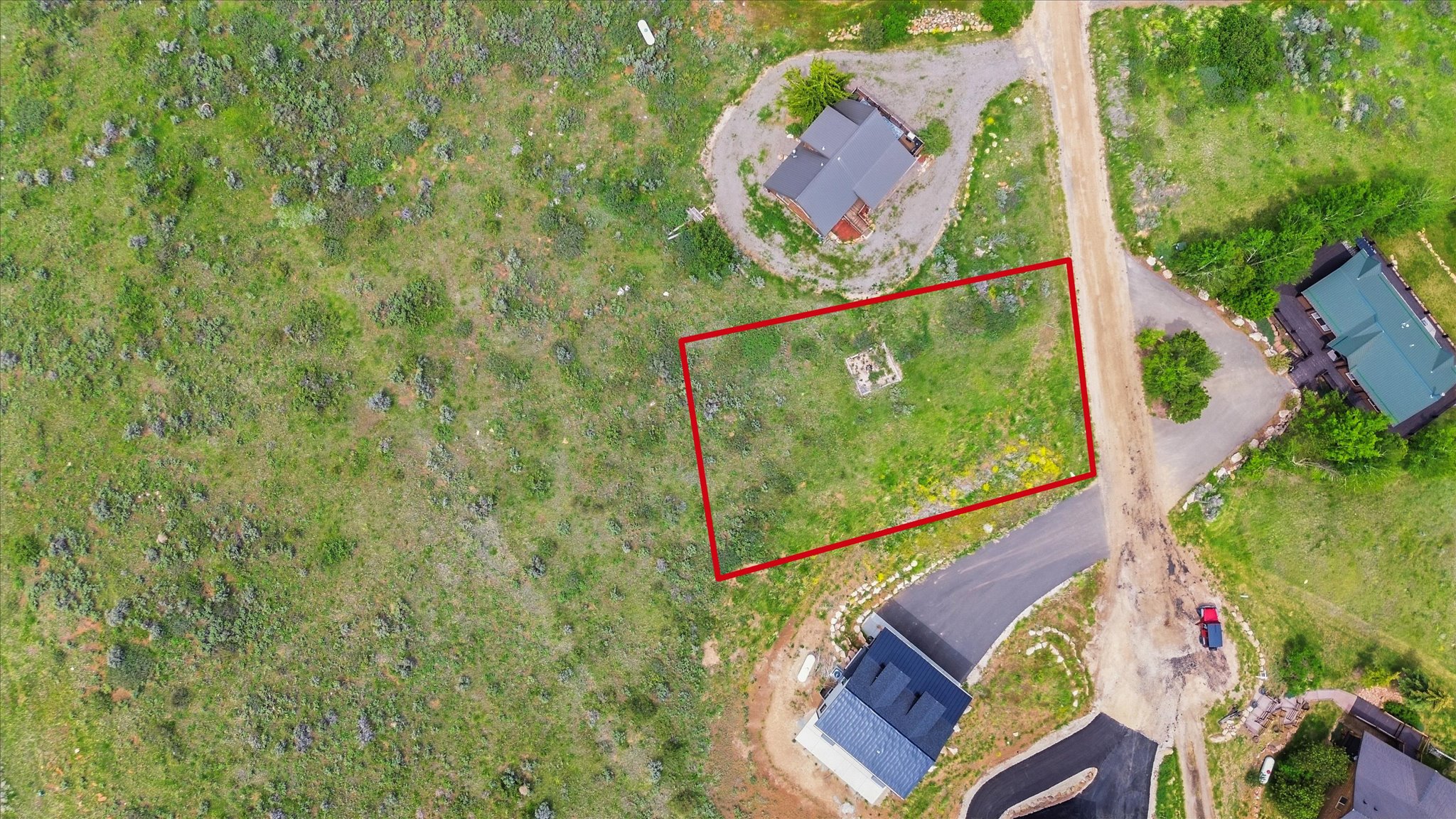 Expansive residential lot featuring lush greenery and visible boundary markers