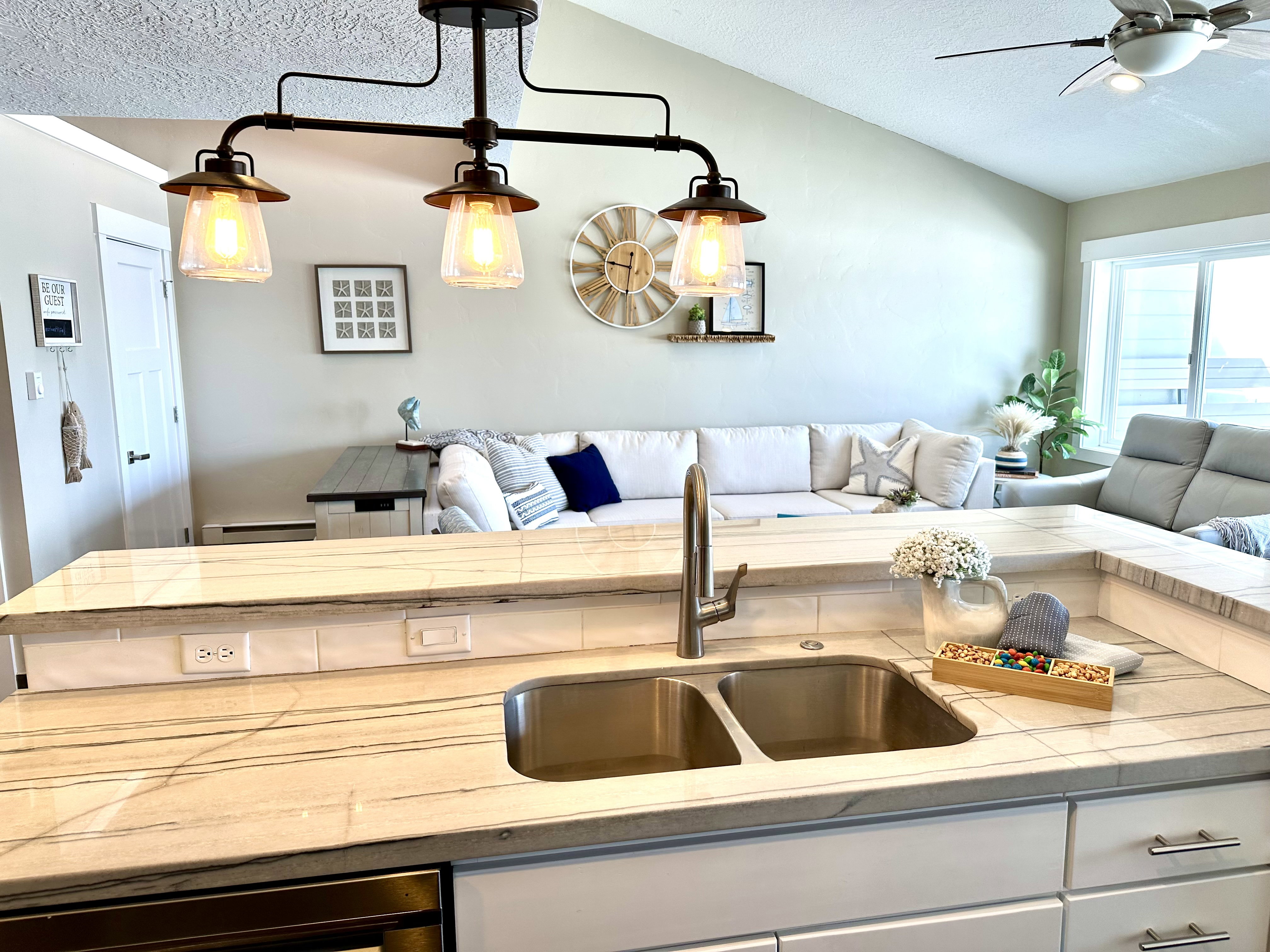 Kitchen island with a double basin stainless steel sink and a gooseneck faucet