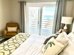 Sliding glass doors open to a private deck with water scenery