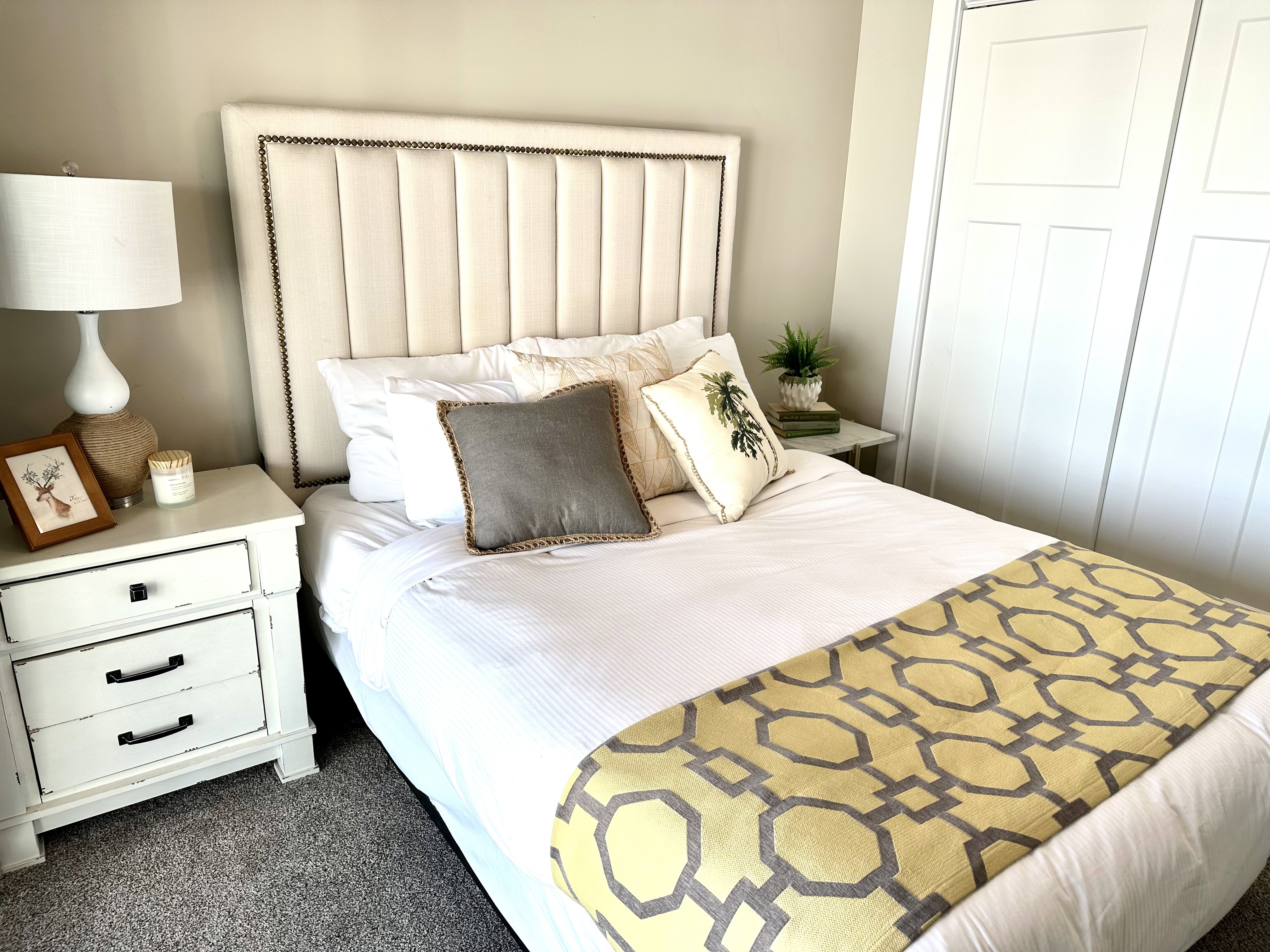 Upholstered panel headboard with nailhead trim