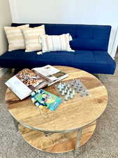 Warm wood-finish coffee table with a lower storage shelf