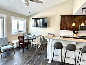 Open-concept kitchen and dining area with wood-finish flooring