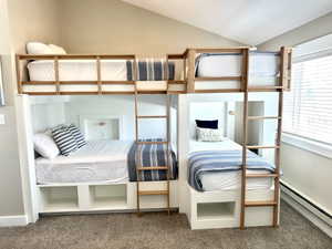 Custom-built bunk beds with integrated storage and natural wood ladders