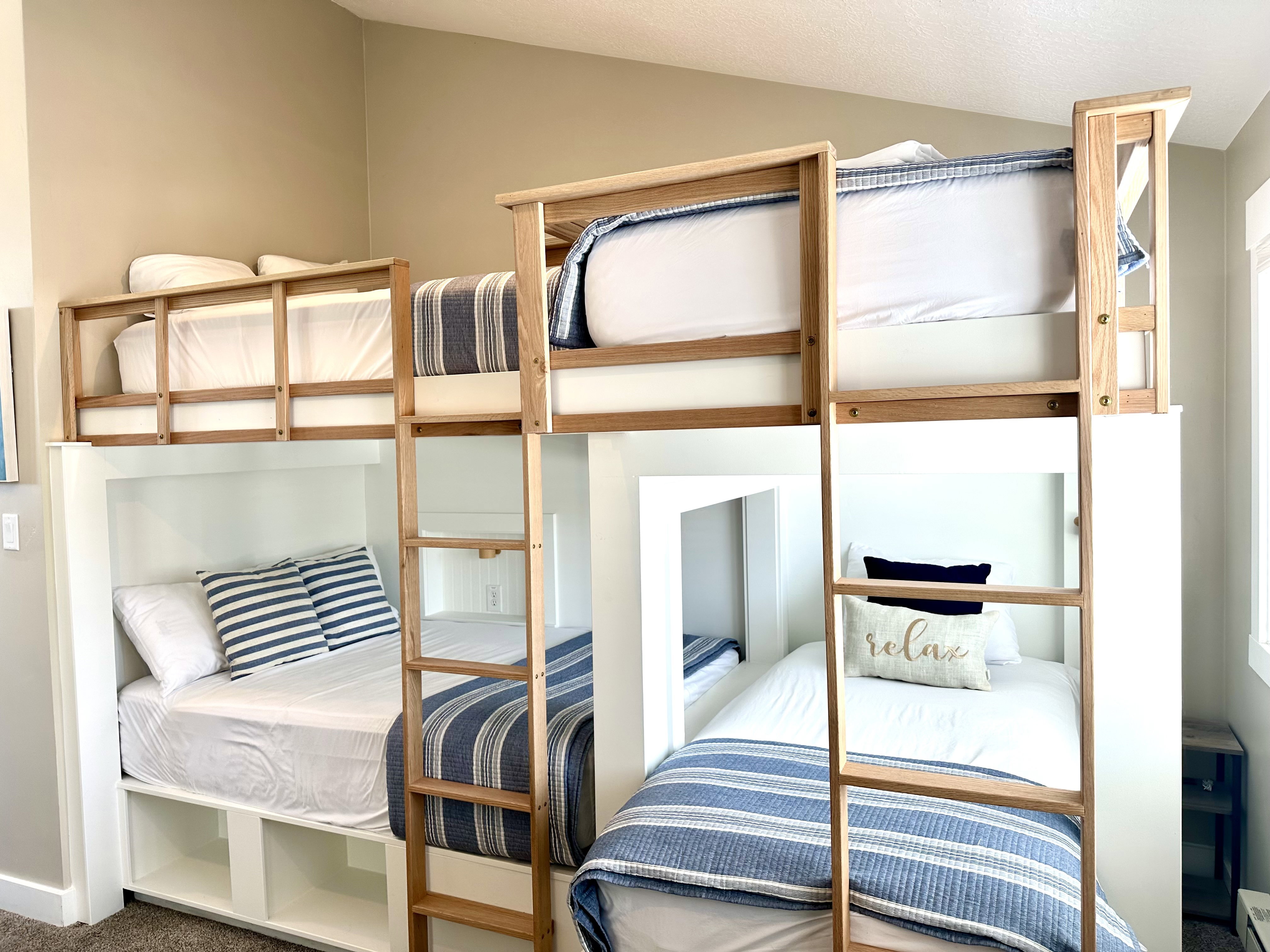 Built-in bunk bed system featuring natural wood-finish ladders and safety rails