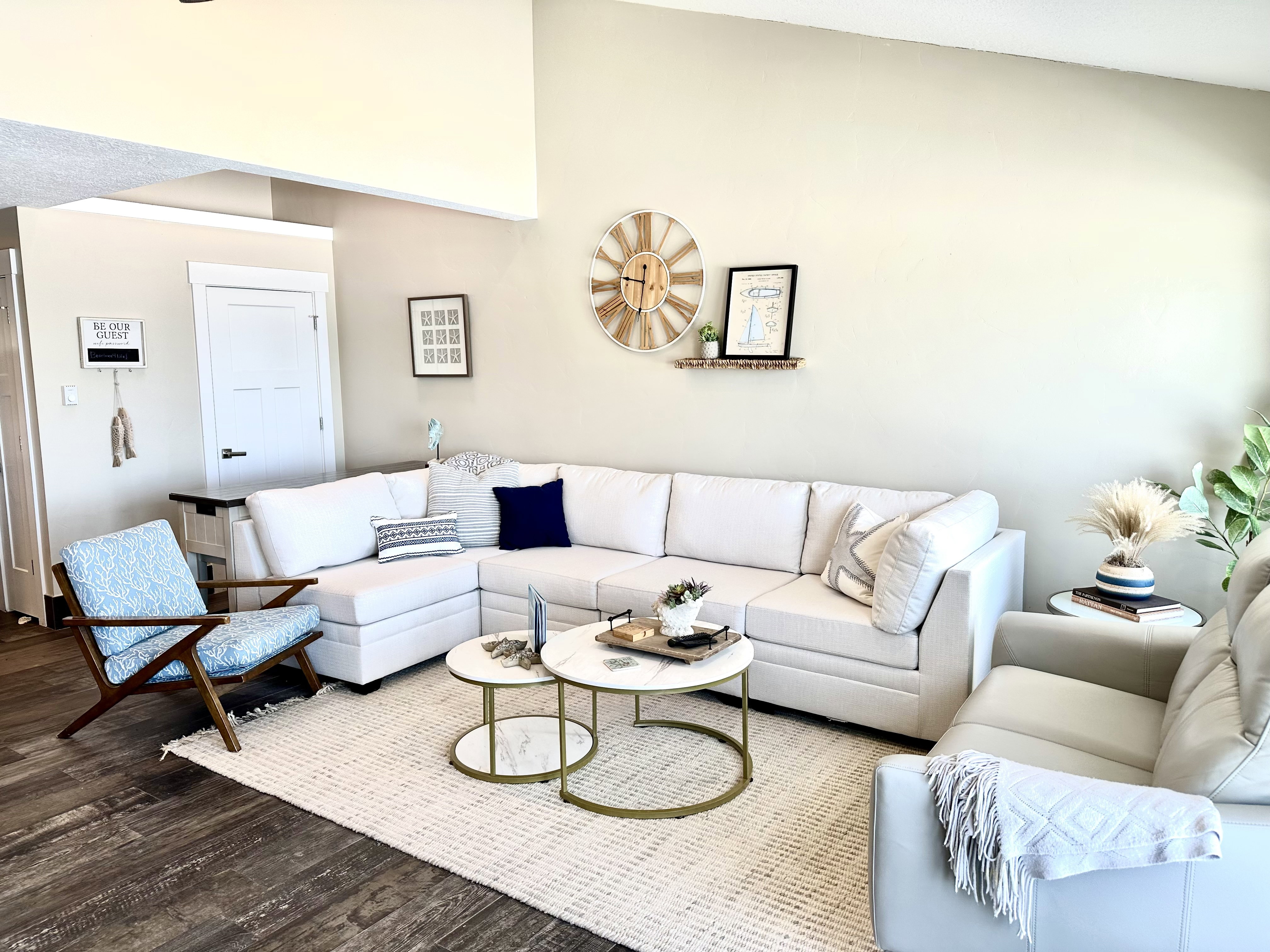 Living area featuring vaulted ceilings, wood-finish flooring, and a large area rug