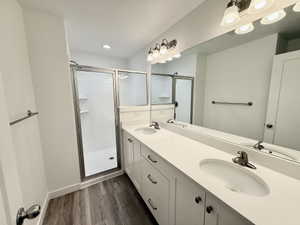 Bathroom featuring a dual vanity with white cabinetry, white countertops, and undermount sinks