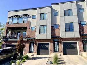 Modern townhome exterior featuring brick and panel siding