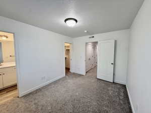 Spacious room featuring neutral carpeting, white walls, and a semi-flush mount ceiling light