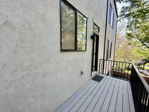 Exterior balcony featuring composite decking and black metal railings