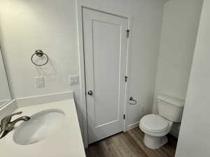 Contemporary bathroom featuring a white vanity with an integrated sink and brushed nickel faucet