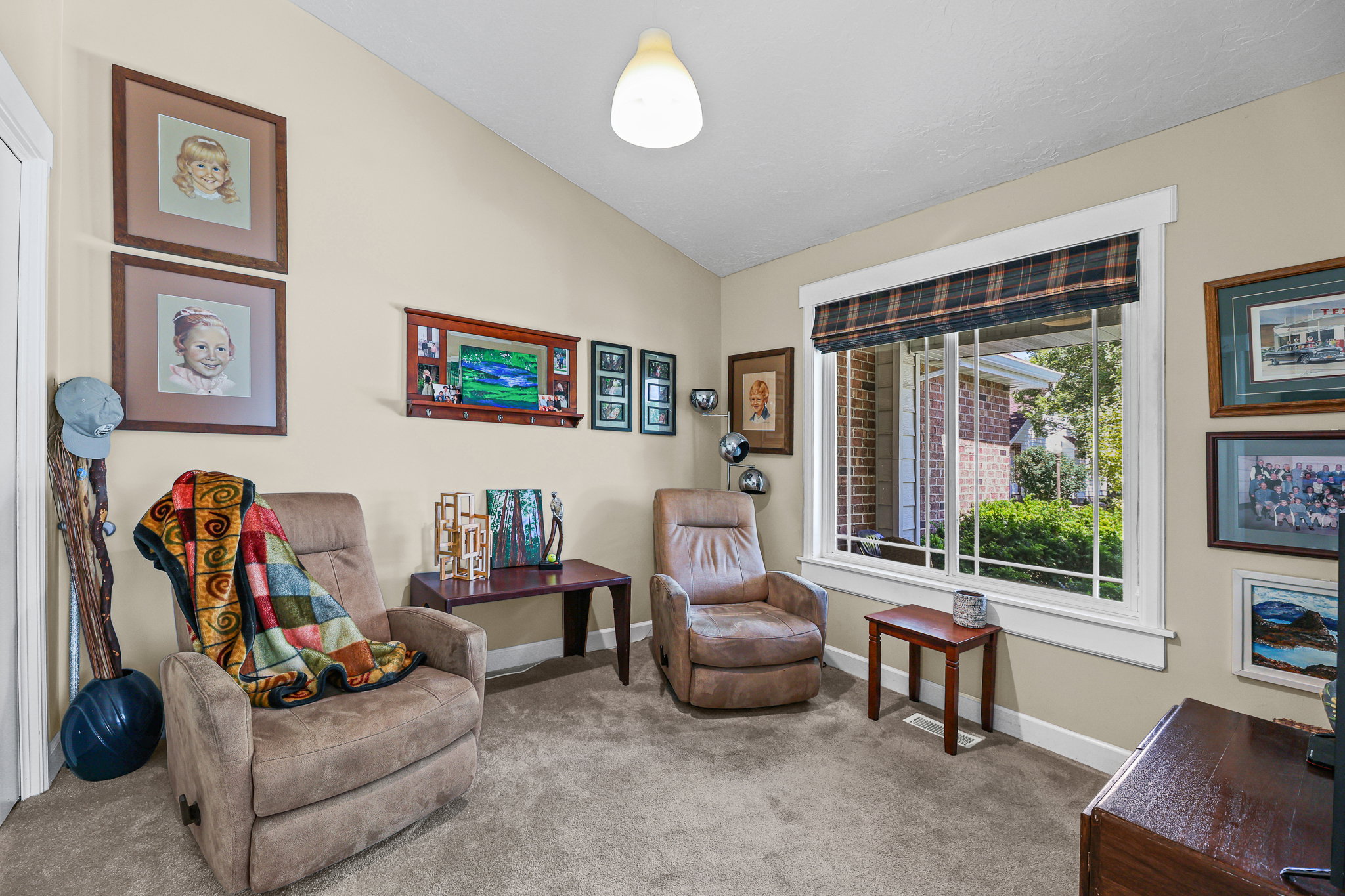 Room featuring vaulted ceilings and neutral wall tones