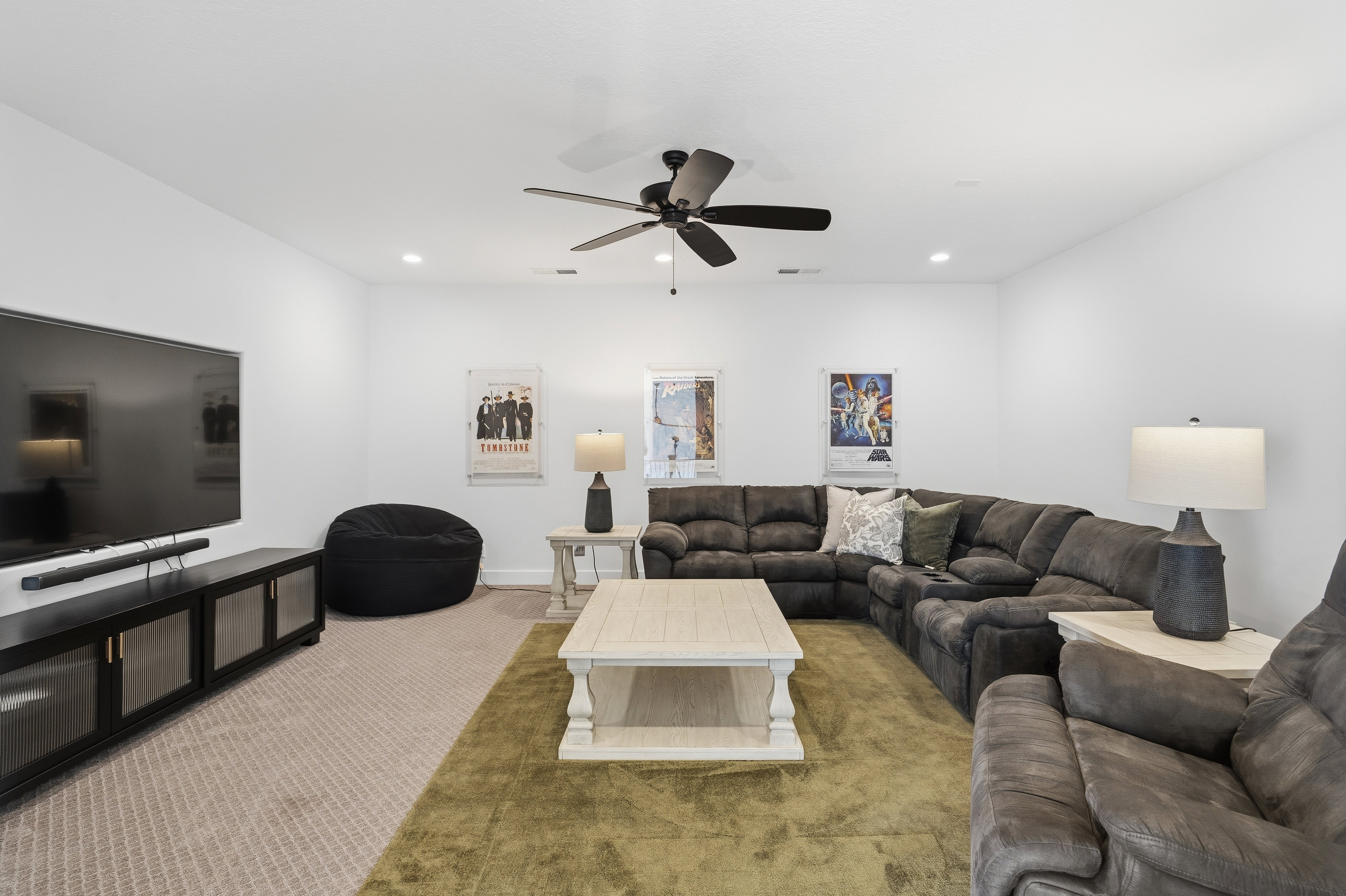 Spacious interior featuring a neutral color palette, recessed lighting, and a ceiling fan.