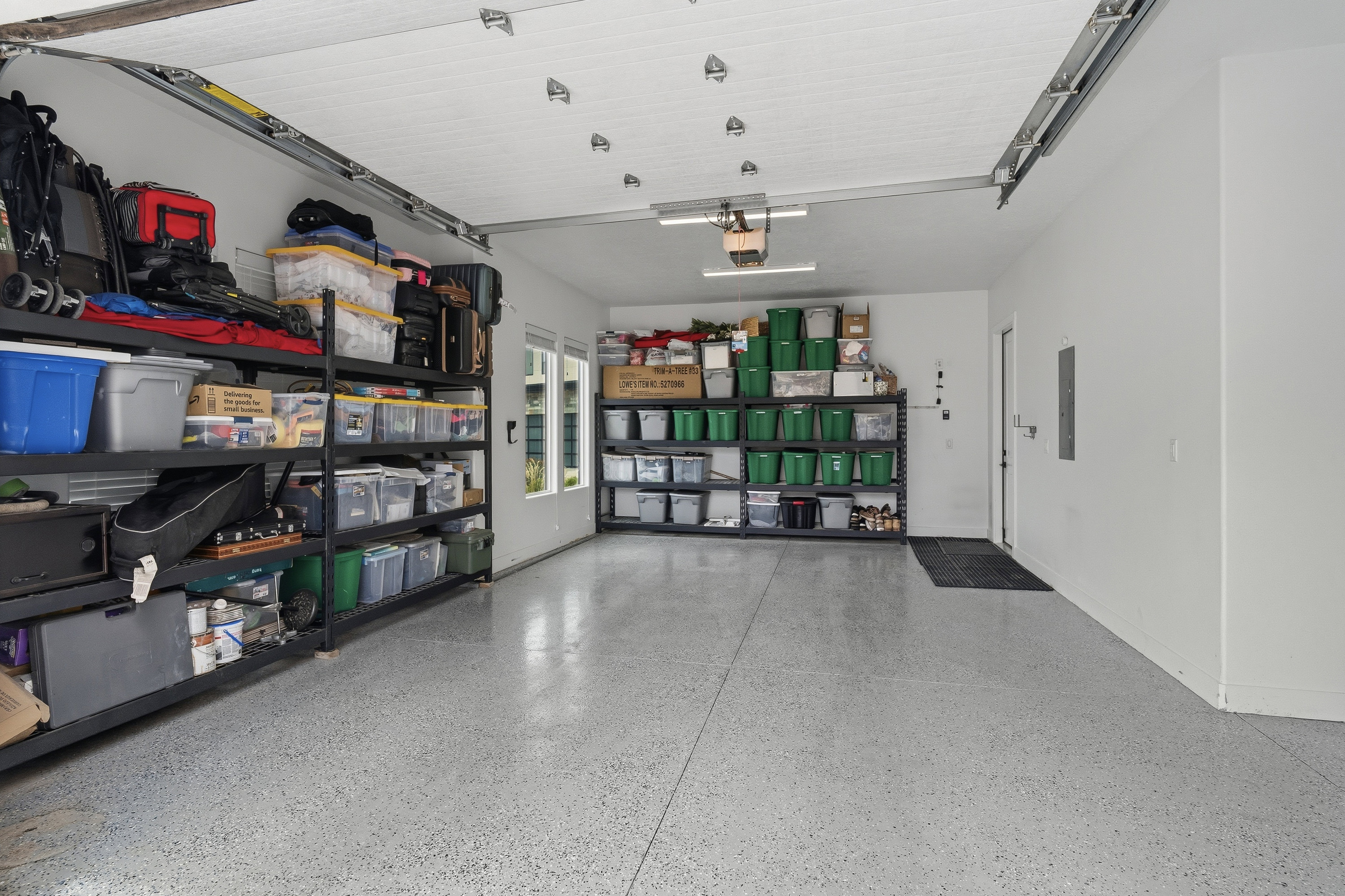 Spacious garage with light gray speckled epoxy flooring.