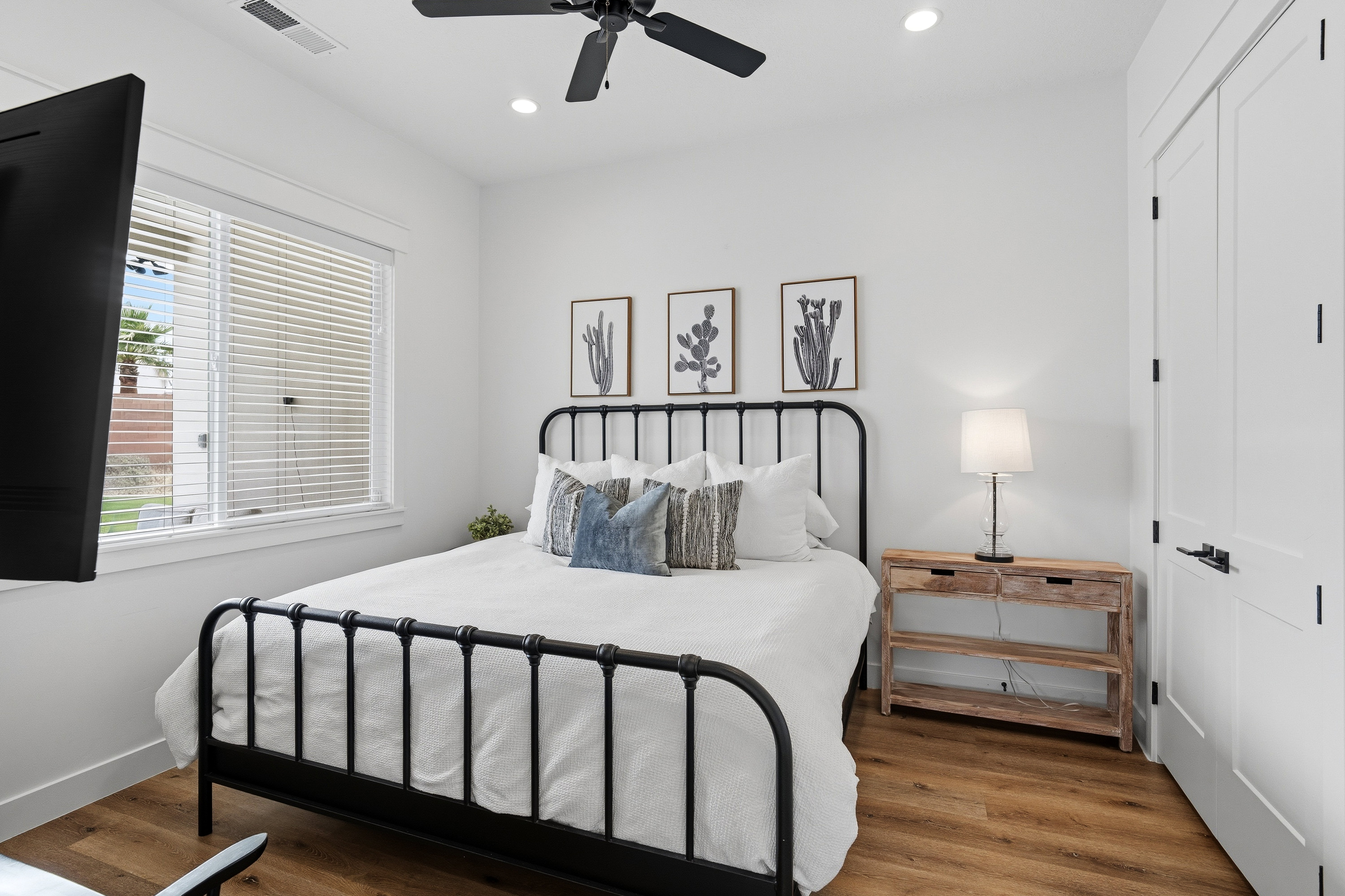 Bright interior space featuring wood-finish flooring, a ceiling fan, recessed lighting, and white trim.