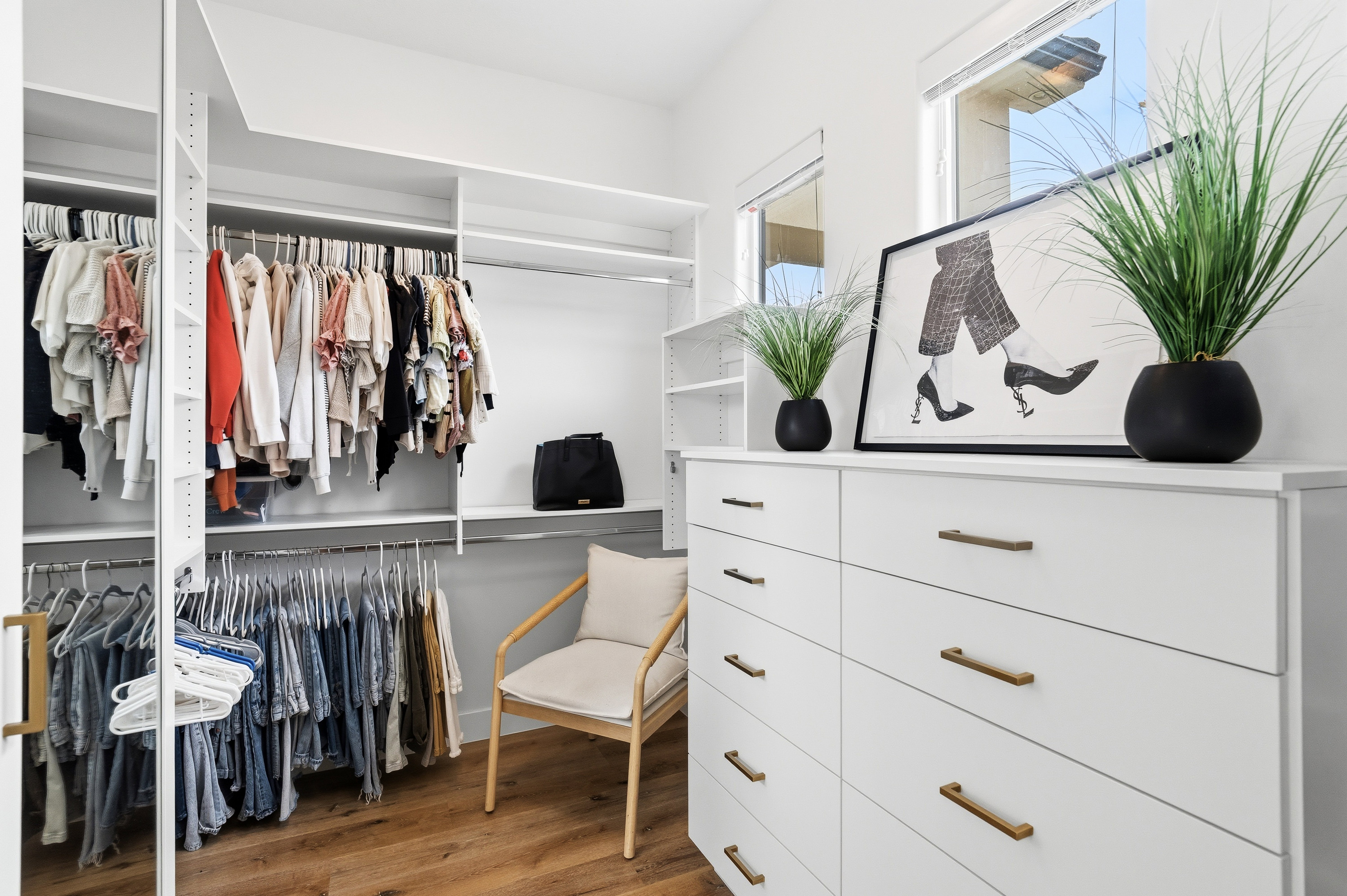 Custom closet system featuring multiple hanging rods and integrated shelving.