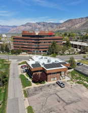 Brick-clad commercial building with a flat roof featuring solar panel arrays