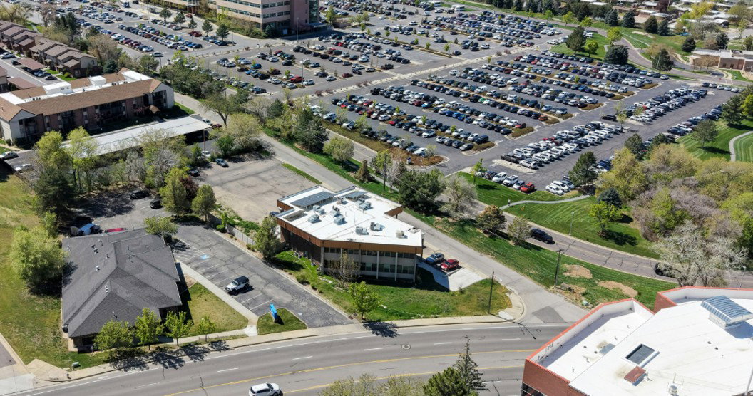 Commercial building with an angular roofline and multiple parking areas