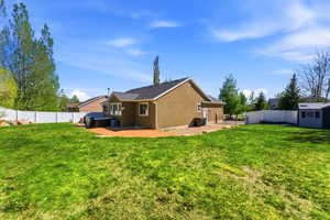 Expansive green lawn with a white privacy fence