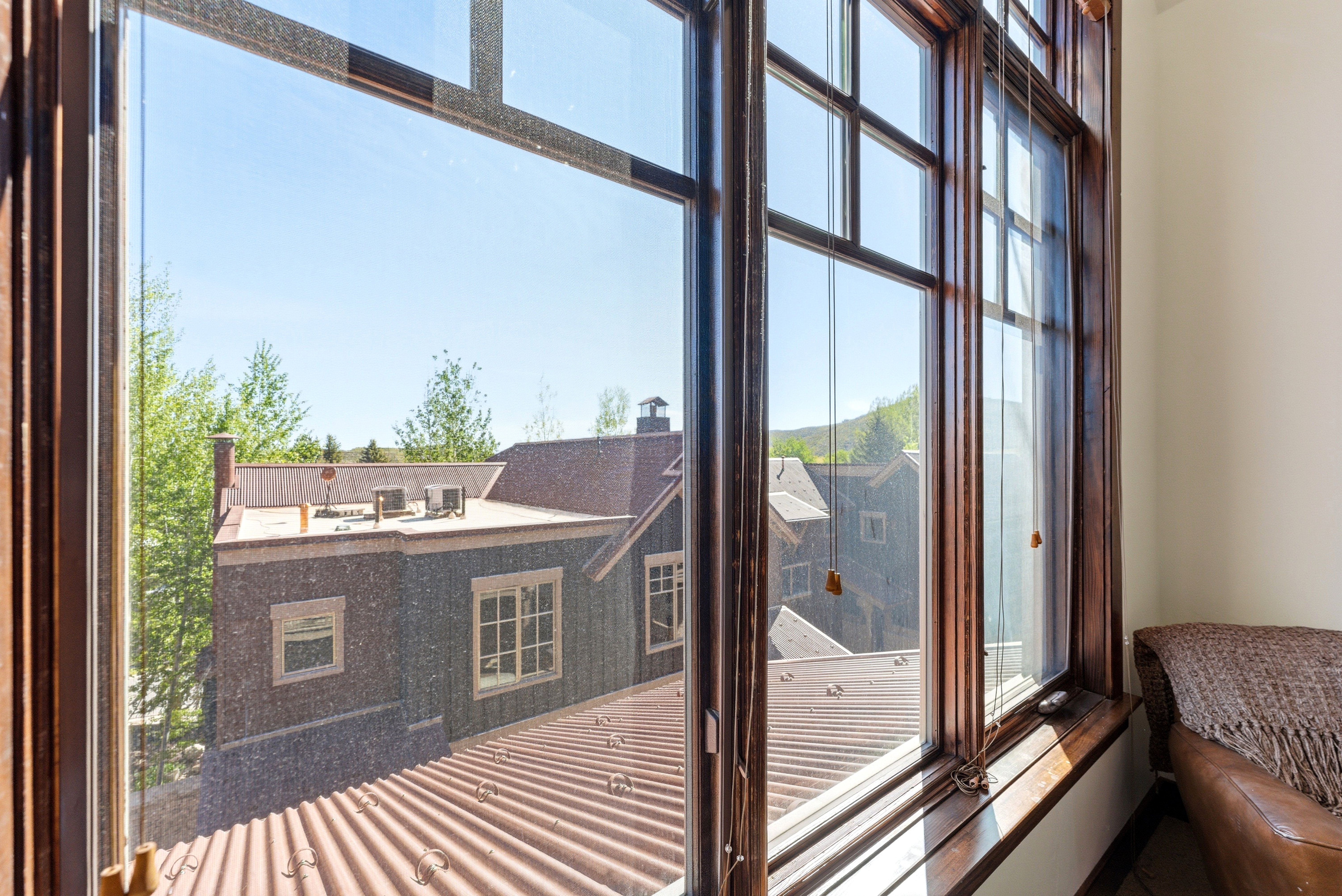 Large multi-pane window with rich wood framing