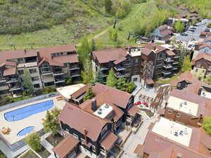 Community aerial showcasing multiple buildings with consistent copper-toned roofing