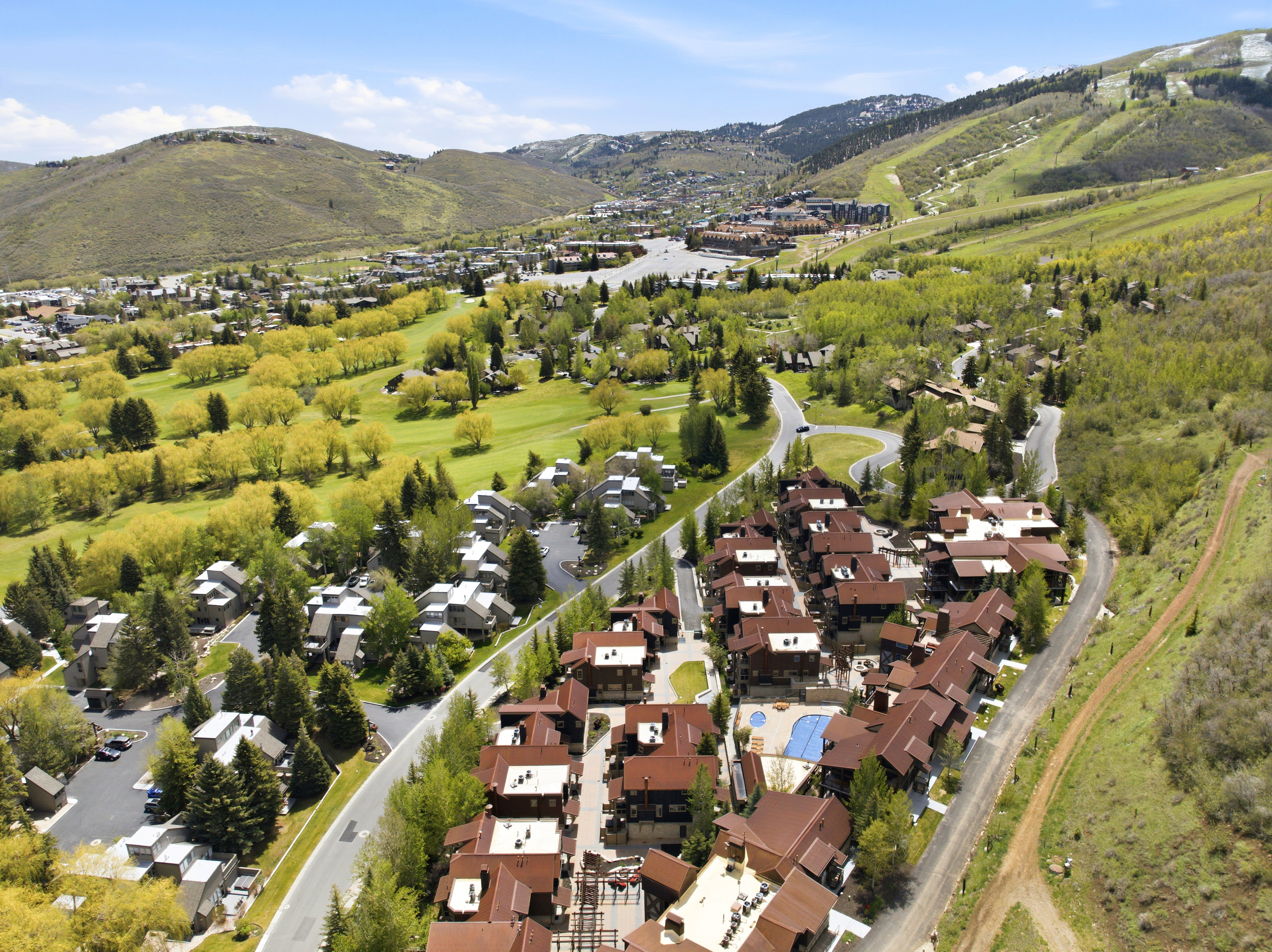Aerial perspective showcasing a residential community amidst a mountainous landscape