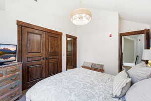 Room featuring vaulted ceilings and a statement woven pendant light fixture