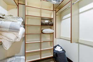 Custom closet system featuring extensive shelving and multiple hanging rods