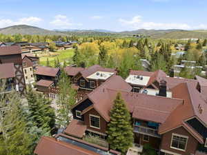 Contemporary multi-level residences featuring brown metal roofs and dark wood siding