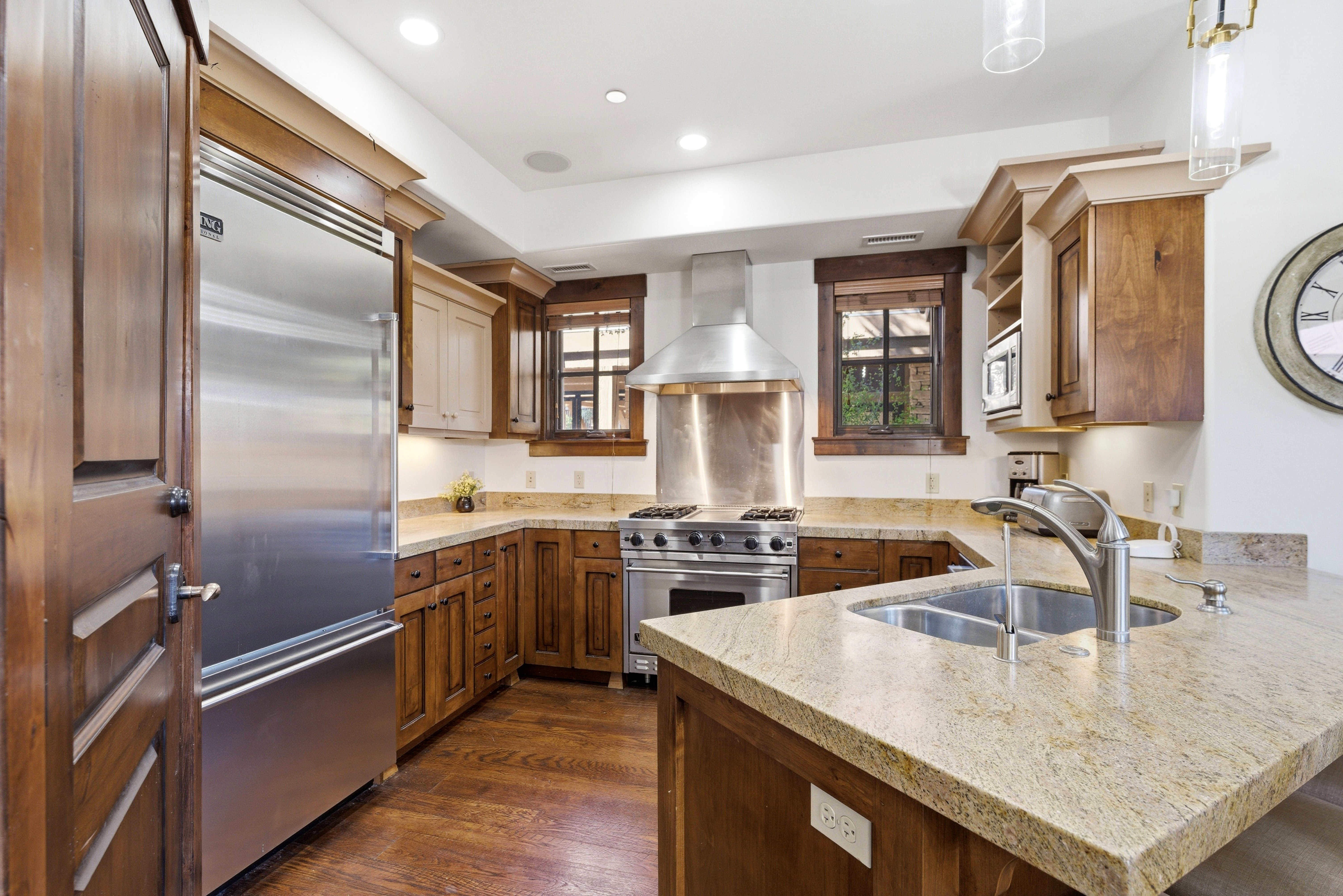 Gourmet kitchen featuring a stainless steel Viking refrigerator, professional-grade range, built-in microwave, and granite countertops