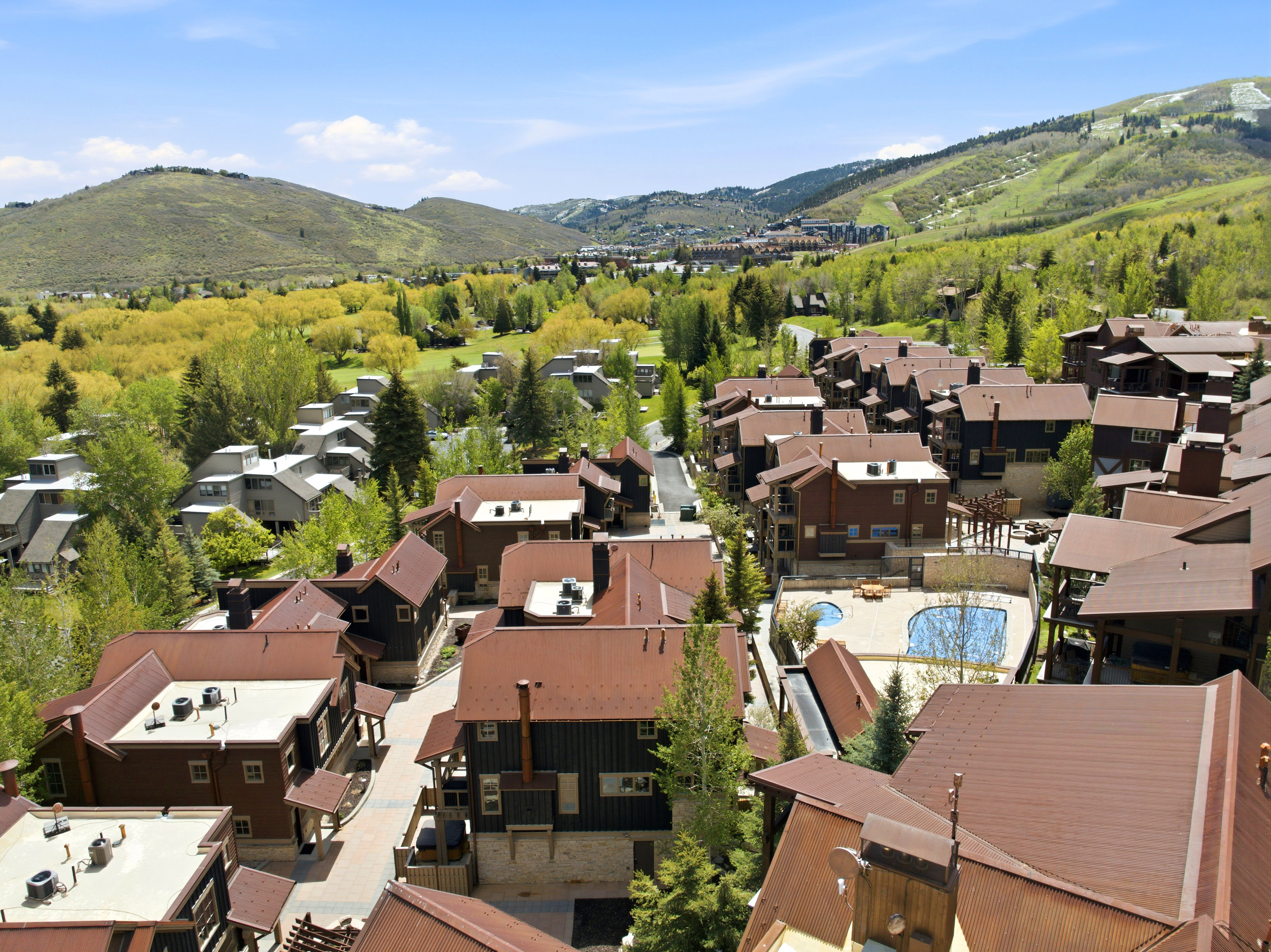 Aerial perspective showcasing a community of homes with sloped roofs and varied architectural designs