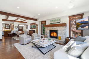 Living area with a stone-clad fireplace and wood mantle