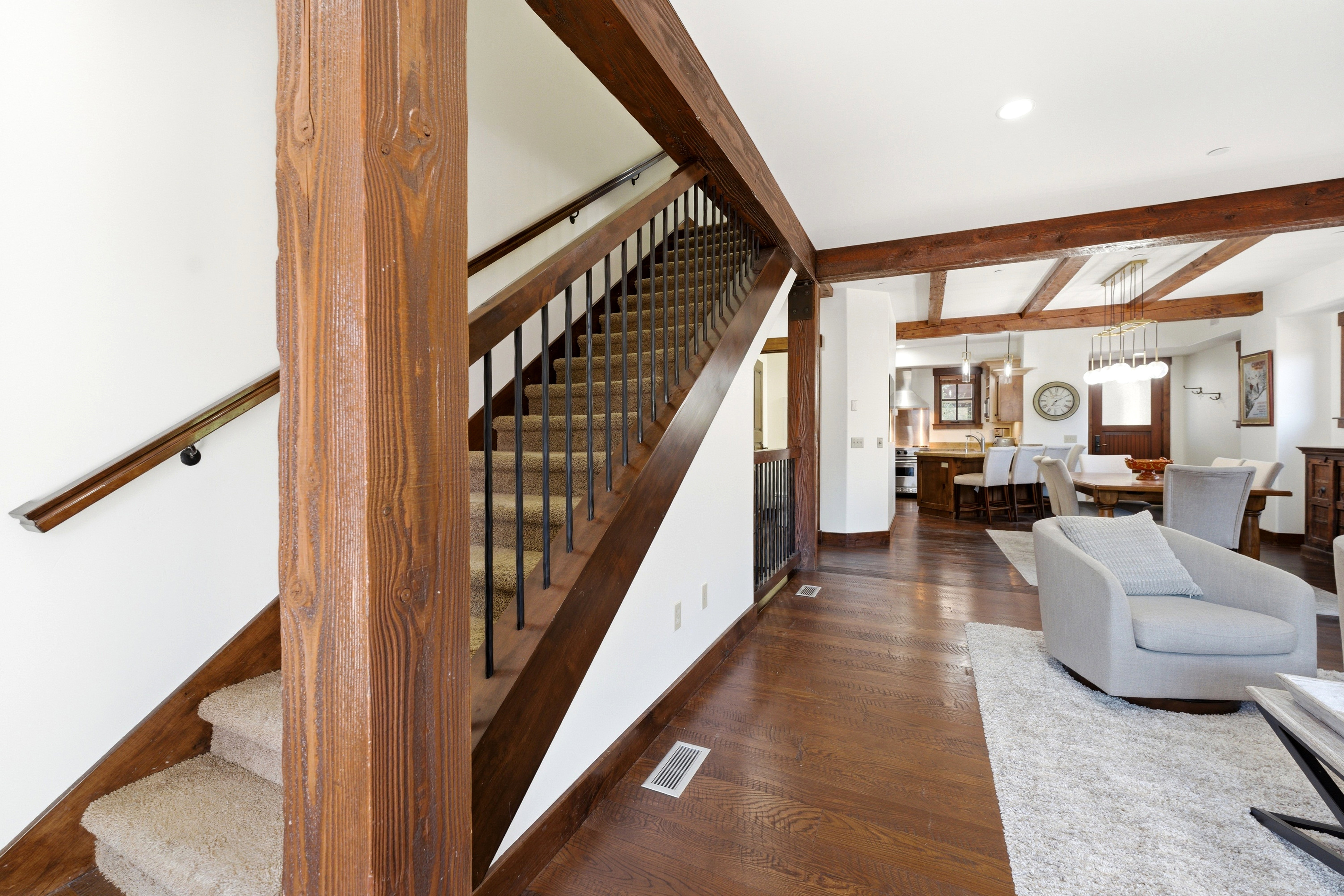 Exposed wood beams and columns complement the rich wood-finish flooring