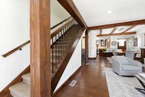 Exposed wood beams and columns complement the rich wood-finish flooring