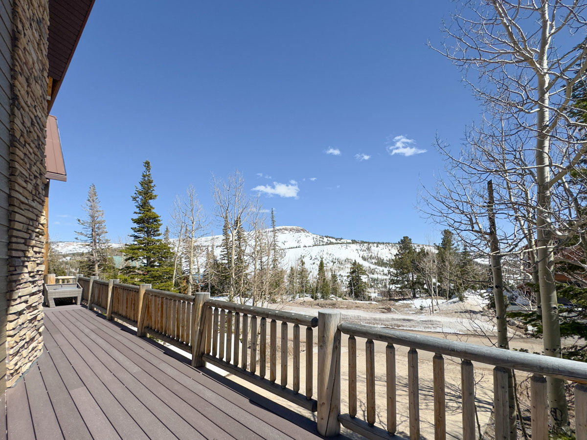 Spacious outdoor deck with composite decking and rustic wood railing