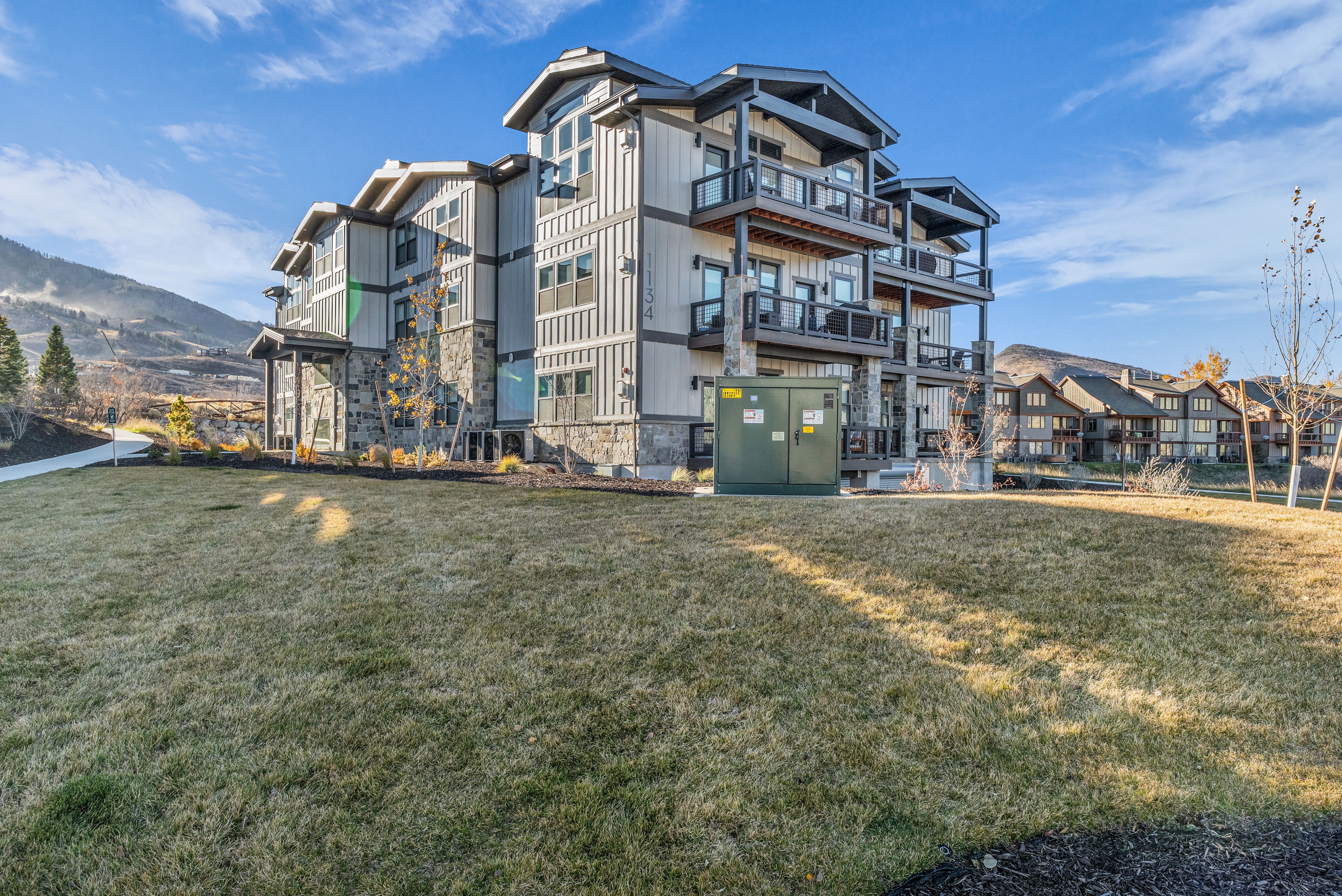 Contemporary multi-story exterior with vertical siding and stone accents