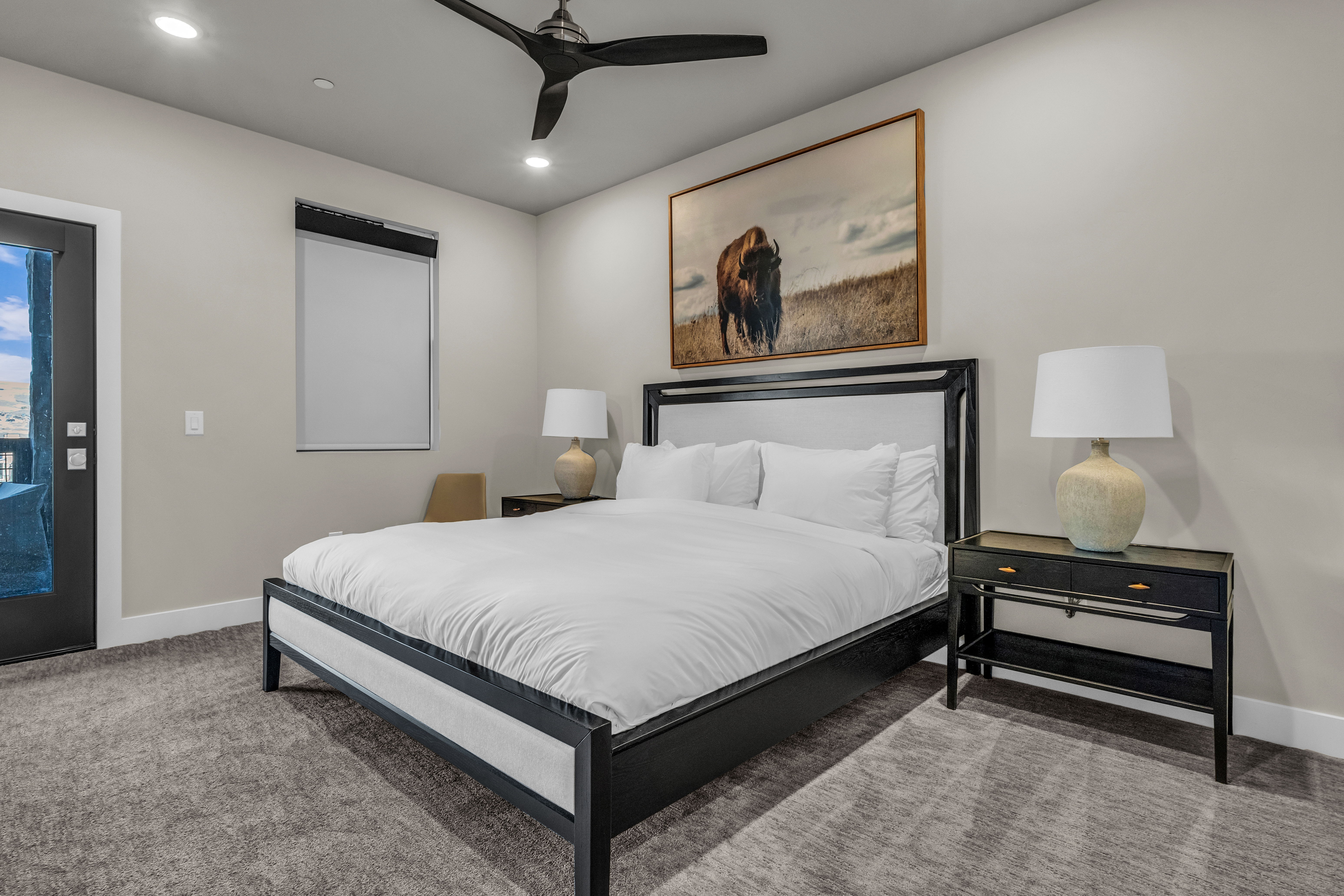 Carpeted room featuring a ceiling fan with recessed lighting, an exterior door with glass panels, and a window with blinds