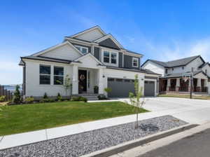 Modern two-story residence featuring a white brick and dark siding facade