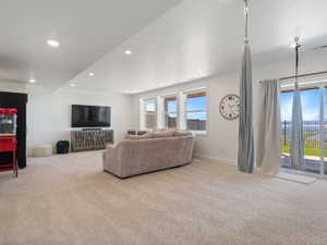 Spacious room featuring light-colored carpeting and recessed ceiling lighting