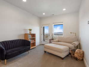 Carpeted room featuring a white wall finish, recessed lighting, and a white baseboard trim