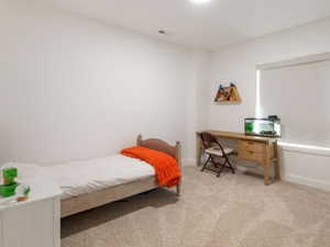 Bright room featuring light-colored carpeting and white walls