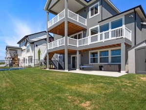 Expansive green lawn with a two-story deck featuring white railings