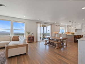 Spacious open-concept living area featuring light wood-finish flooring