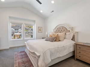 Vaulted ceiling bedroom featuring recessed lighting, a ceiling fan, and large windows with privacy blinds